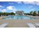 Community pool with lounge chairs and umbrellas, and a covered pavilion at 13624 Jacks Ln, Pineville, NC 28134