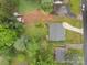 An aerial view showcases the property's layout with well-maintained landscaping and a driveway to a cozy home at 1401 Thompson Ave, Charlotte, NC 28216