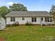 The backyard features home exterior, storage shed, and green grass at 1401 Thompson Ave, Charlotte, NC 28216