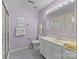 Well-lit bathroom with a single vanity, ample storage, and a walk-in shower at 1401 Thompson Ave, Charlotte, NC 28216