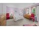 Serene bedroom with light purple walls, classic wood furniture, and lots of natural light at 1401 Thompson Ave, Charlotte, NC 28216