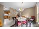 Sunny eat-in kitchen with tile flooring, neutral walls, and a chandelier at 1401 Thompson Ave, Charlotte, NC 28216