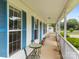 Charming front porch with a seating area with an outdoor table and chairs at 1401 Thompson Ave, Charlotte, NC 28216