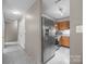Spacious kitchen features stainless steel refrigerator and views into adjoining rooms at 1401 Thompson Ave, Charlotte, NC 28216