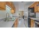 Practical kitchen boasts plenty of counter space, modern appliances, and wood cabinets at 1401 Thompson Ave, Charlotte, NC 28216