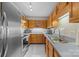Efficient kitchen features oak cabinets, stainless steel appliances, and ample counter space at 1401 Thompson Ave, Charlotte, NC 28216