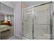 Bathroom walk-in shower featuring a sliding glass door and chrome fixtures at 1401 Thompson Ave, Charlotte, NC 28216