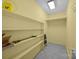Organized storage room with shelving, checkered floors, and good overhead lighting at 1401 Thompson Ave, Charlotte, NC 28216