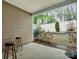 Inviting back patio with wooden stools overlooking a landscaped backyard with vibrant flowers and greenery at 145 Marron Dr, Indian Trail, NC 28079