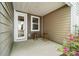 Covered back patio with seating area, perfect for outdoor relaxing and entertaining with landscaping at 145 Marron Dr, Indian Trail, NC 28079