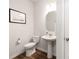 Clean half bath featuring tile floors, pedestal sink, and updated fixtures at 145 Marron Dr, Indian Trail, NC 28079