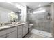 Elegant bathroom with a glass-enclosed shower, double vanity, and granite countertops at 145 Marron Dr, Indian Trail, NC 28079