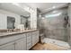 Elegant bathroom featuring double sinks, granite countertops, a glass shower, and neutral color palette at 145 Marron Dr, Indian Trail, NC 28079