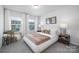 Bright bedroom featuring a stylish platform bed, bedside tables, and neutral decor at 145 Marron Dr, Indian Trail, NC 28079