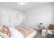 Bright, carpeted bedroom showcasing neutral walls, a modern chair, and plush bedding at 145 Marron Dr, Indian Trail, NC 28079