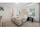 Spacious bedroom showcasing large windows, tray ceiling, and ensuite bath access at 145 Marron Dr, Indian Trail, NC 28079