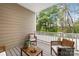 Cozy covered deck with wooden furniture, perfect for relaxation and enjoying views of the surrounding woods at 145 Marron Dr, Indian Trail, NC 28079