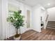 Bright entryway featuring wood floors, a large window, and staircase access at 145 Marron Dr, Indian Trail, NC 28079
