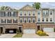 Beautiful multi-story townhome featuring a stone facade, attached garage, and neutral color scheme at 145 Marron Dr, Indian Trail, NC 28079