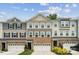 New townhome showcasing brick and siding facade, multiple windows, and a two-car garage at 145 Marron Dr, Indian Trail, NC 28079