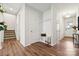 Inviting foyer with coat rack, wooden floors, and access to the stairs and other rooms at 145 Marron Dr, Indian Trail, NC 28079