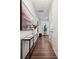 Hallway with hardwood floors, decorative console table, and natural light at 145 Marron Dr, Indian Trail, NC 28079