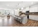 Open-concept kitchen with granite island, pendant lighting, and seamless flow to a cozy living space at 145 Marron Dr, Indian Trail, NC 28079