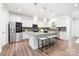 Modern kitchen features stainless steel appliances, granite countertops, and a large central island with bar seating at 145 Marron Dr, Indian Trail, NC 28079