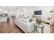 Bright living room featuring wood floors, modern furnishings, and open-concept design with easy access to the kitchen at 145 Marron Dr, Indian Trail, NC 28079