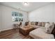 Cozy living room with natural light, a comfortable sectional sofa, and hardwood floors at 145 Marron Dr, Indian Trail, NC 28079