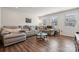 Bright living room with hardwood floors, sectional couch, and ample natural light at 145 Marron Dr, Indian Trail, NC 28079