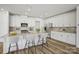 Well-lit kitchen featuring a large island with seating, stainless steel appliances, and white cabinetry at 1529 Gossage Nw Ln, Concord, NC 28027