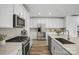 Modern kitchen with stainless steel appliances, gas range, and light countertops at 1529 Gossage Nw Ln, Concord, NC 28027