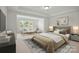 Bright bedroom with a sitting area and a plush bed at 1529 Gossage Nw Ln, Concord, NC 28027