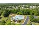 Aerial view of neighborhood pool and clubhouse with ample seating and playground nearby at 16117 Wrights Ferry Rd, Charlotte, NC 28278