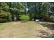 Wide shot of backyard with bench, fire pit, and small playhouses at 16117 Wrights Ferry Rd, Charlotte, NC 28278