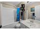 Bathroom featuring a single sink vanity, shower-tub combo with colorful blue curtain at 16117 Wrights Ferry Rd, Charlotte, NC 28278