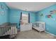 Bright Bedroom with two cribs, changing table and playful decor at 16117 Wrights Ferry Rd, Charlotte, NC 28278