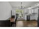 Bright dining area featuring a modern chandelier, view to the kitchen and exterior views at 16117 Wrights Ferry Rd, Charlotte, NC 28278