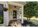 Welcoming front porch with a decorative door, potted plants, and cozy 'Welcome' mat at 16117 Wrights Ferry Rd, Charlotte, NC 28278