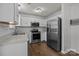 A modern kitchen with white cabinets, stainless steel appliances, and a stylish subway tile backsplash at 16117 Wrights Ferry Rd, Charlotte, NC 28278