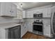 This is a well-lit kitchen featuring white cabinets, stainless steel appliances, and subway tile backsplash at 16117 Wrights Ferry Rd, Charlotte, NC 28278