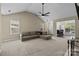 Open-concept living room with a large sectional couch, fireplace, and views to the dining area at 16117 Wrights Ferry Rd, Charlotte, NC 28278