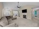 Comfortable living area with a fireplace, television, and doorway views to other rooms at 16117 Wrights Ferry Rd, Charlotte, NC 28278