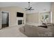 Spacious living room with a fireplace, neutral carpet, and a comfortable sectional sofa at 16117 Wrights Ferry Rd, Charlotte, NC 28278