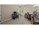 A carpeted room featuring two desk setups with computer, chair, and lighting at 16117 Wrights Ferry Rd, Charlotte, NC 28278