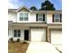 Charming townhome with white siding, stone accents, and single-car garages at 175 Limerick Rd # C, Mooresville, NC 28115