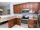 Well-equipped kitchen features wood cabinets, granite counters, and stainless steel appliances at 175 Limerick Rd # C, Mooresville, NC 28115