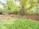 Large, well-kept backyard with healthy grass, wood fence, and shade trees at 1847 J Julian Ln # A, Charlotte, NC 28208