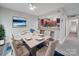 Open dining area with view to kitchen, modern table set, and natural light at 1847 J Julian Ln # A, Charlotte, NC 28208